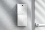 Loxone Intercom in white on a grey wall beside a door, shown with NFC Code Touch, sold separately