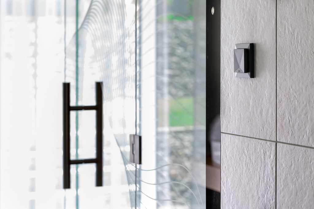Loxone Room Comfort Sensor Tree in anthracite on a wall beside a door