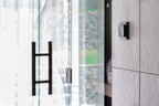 Loxone Room Comfort Sensor Tree in anthracite on a wall beside a door